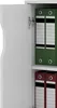 A close-up view of an open white cabinet with green and red binders on shelves. Produktbild-Vorschau