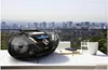 A Philips boombox is placed on a table outdoors with a city skyline in the background. Produktbild-Vorschau