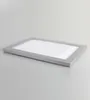 A silver picture frame lies flat on a light gray surface. Produktbild-Vorschau