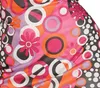 A close-up of a colorful, patterned fabric with a retro, 70s-inspired design. Produktbild-Vorschau