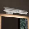 A modern LED bathroom light fixture mounted above a mirror, with a reflection of trees visible in the mirror. Produktbild-Vorschau