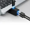 A black USB hub adapter is connected to a laptop, with two USB cables plugged into the hub. Anteprima dell’immagine prodotto