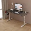 A modern standing desk setup with a computer, keyboard, mouse, lamp, and headphones. Náhled obrázku produktu