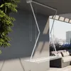A white ceiling-mounted drying rack is shown extended on a balcony with a city view. Podgląd zdjęcia produktu
