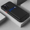 A black phone case with a card holder attached, shown on a light gray and white surface. Produktbild-Vorschau