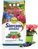 A bag of fertilizer with flowers and berries depicted on it, next to a potted plant. Podgląd zdjęcia produktu
