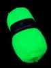 A ball of neon green yarn on a black background. Produktbild-Vorschau