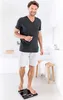 A man is standing on a scale in a bathroom. Produktbild-Vorschau