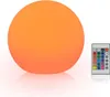 A glowing orange sphere lamp and a remote control on a white background. Produktbild-Vorschau