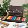 A wooden art case filled with colored pencils and art supplies, set on a table with art paper and rolls of decorative paper. Anteprima dell’immagine prodotto