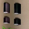 Four wall lights mounted on a textured wall. Produktbild-Vorschau