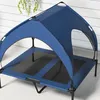 An elevated dog bed with a blue canopy, shown outdoors on a patio. Anteprima dell’immagine prodotto