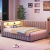 A modern bedroom with a L-shaped bed featuring integrated LED lighting and a tablet on the pillows. Náhled obrázku produktu