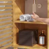 A hand reaches for rolled towels on a shelf in a wooden cabinet. Podgląd zdjęcia produktu