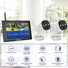 A security camera system with a monitor and two cameras, displayed on a white surface with a window in the background. Anteprima dell’immagine prodotto