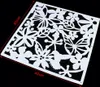 A white stencil with a floral and butterfly design on a black background. Náhled obrázku produktu