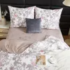 A neatly made bed with floral patterned bedding, pillows, and a decorative cushion. Podgląd zdjęcia produktu