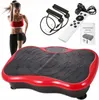 A woman is shown exercising next to a vibration platform, with accessories and instructions in the background. Náhľad obrázku produktu