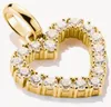 A close-up shot of a gold heart-shaped charm pendant with clear stones, set against a white background. Voir les images du produit