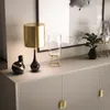 A modern dresser with decorative items on top. Produktbild-Vorschau