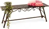 A metal garden bench with a potted plant and a cushion. Anteprima dell’immagine prodotto