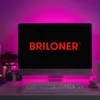A computer monitor displaying a logo, with pink LED lighting in the background. Produktbild-Vorschau