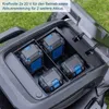 Close-up view of a lawnmower's battery compartment with four batteries installed, with text overlay describing battery power. Produktbild-Vorschau
