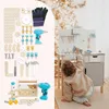 A child playing with a toy workbench and tools, with a Christmas tree in the background. Produktbild-Vorschau