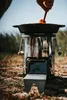 A person is cooking on a portable stove outdoors. Produktbild-Vorschau