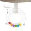 A close-up of a baby toy rattle ring with colorful beads inside, attached to a fabric strap. Produktbild-Vorschau