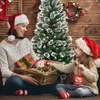 A mother and daughter are sitting in front of a decorated Christmas tree, holding Christmas ornaments and gifts. Náhľad obrázku produktu