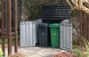 A storage unit for trash cans in an outdoor garden setting. Náhled obrázku produktu