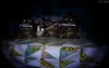 Three animatronic characters are sitting on a bed in a dark room. Produktbild-Vorschau