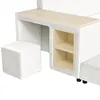 A close-up view of a white upholstered bed frame with a wooden desk surface and built-in shelving. A white upholstered stool is positioned to the left of the desk. Produktbild-Vorschau