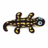 A plush toy salamander with black and yellow spots and blue eyes lies on a white background. Anteprima dell’immagine prodotto