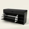 A black shoe cabinet with a cushioned seat on top and pull-out shelves in the front. Náhľad obrázku produktu