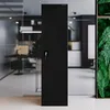 A black metal cabinet with a key lock is shown in a modern office setting with glass walls and plants. Náhľad obrázku produktu
