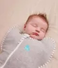 A baby sleeping in a swaddle bag. Produktbild-Vorschau