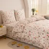 A neatly made bed with floral patterned bedding. Produktbild-Vorschau