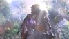 A person in a shiny outfit stands in a sun-dappled forest. Podgląd zdjęcia produktu
