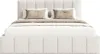 A bed with a headboard and frame upholstered in a textured white fabric, with two pillows and a throw blanket on top. Produktbild-Vorschau