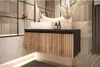 A modern bathroom vanity with a sink and faucet, decorated with a vase of dried flowers and geometric patterned tiles. Produktbild-Vorschau