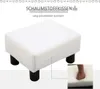 A white footstool with black legs is shown on a white background. A close-up inset shows a foot pressing into the foam cushion. Produktbild-Vorschau