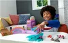 A young boy is playing with a Hot Wheels skate set on a table. Náhled obrázku produktu