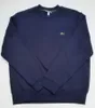 A navy blue Lacoste sweatshirt is laid flat on a white background. Anteprima dell’immagine prodotto