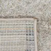 A close-up view of the corner of a rug, showing both the top pile and the underside with its woven pattern. Produktbild-Vorschau