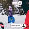 A young girl holding a blue sled in a snowy environment. Náhled obrázku produktu