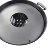 A close-up, top-down view of a grill accessory, likely a fire plate, placed on a white background. The accessory is circular with a central opening revealing a grill grate. A handle is visible on the right side, and a small flame-like logo is present on th Voir les images du produit