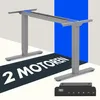A gray electric standing desk frame with a control panel and text overlay. Produktbild-Vorschau