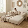 A woman is reading a book on a modular sofa in a living room. Voir les images du produit